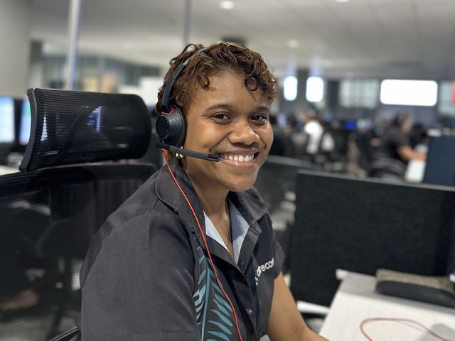 Smiling Centrecom team member on a headset in the Fiji contact centre