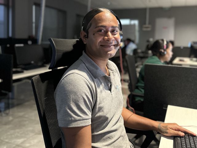 Centrecom team member working on a headset in the Fiji office